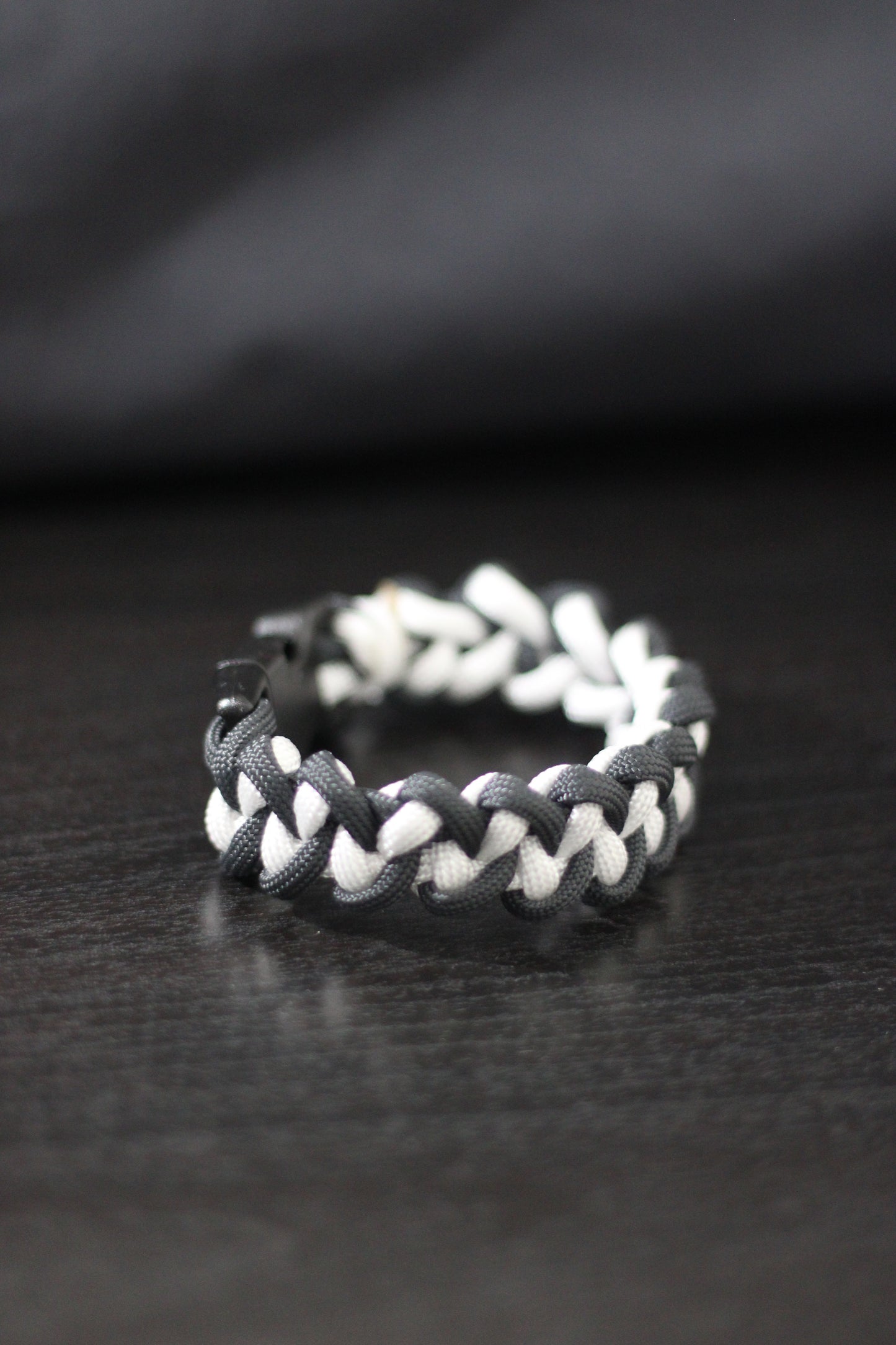 Anthracite and white braided cross bracelet