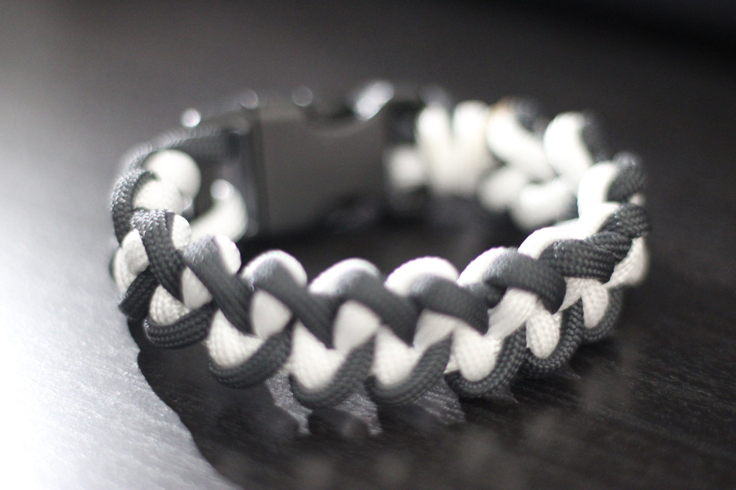 Anthracite and white braided cross bracelet
