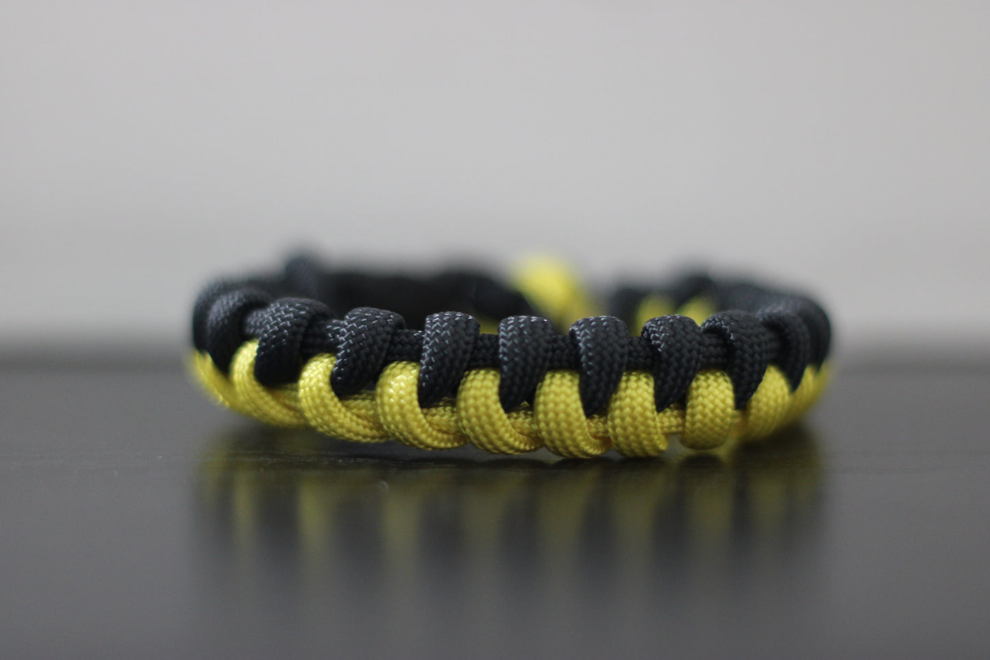 Yellow and black half-braided bracelet