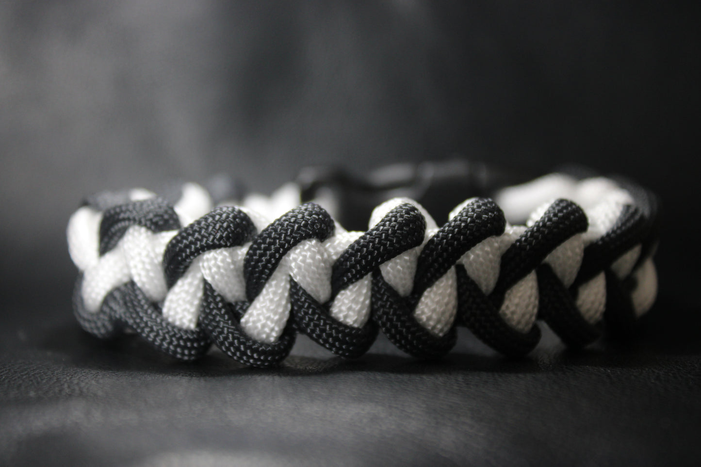 Anthracite and white braided cross bracelet